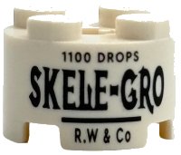 LEGO part Brick, Round 2 x 2 with Axle Hole with Black '1100 DROPS', 'SKELE-GRO' and 'R.W & Co' Pattern 3941pb61