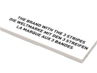 LEGO part Tile 2 x 6 with Black 'THE BRAND WITH THE 3 STRIPES', 'DIE WELTMARKE MIT DEN 3 STREIFEN', and 'LA MARQUE AUX 3 BANDES' Pattern 69729pb006