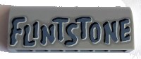 LEGO part Slope, Curved 1 x 4 x 1 1/3 with 'FLINTSTONE' Pattern 6191pb021