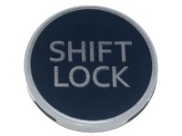 LEGO part Tile, Round 3 x 3 with Silver 'SHIFT LOCK' on Black Background Pattern 67095pb010