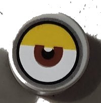 LEGO part Tile, Round 1 x 1 with White Eye with Centered Reddish Brown Iris and Partially Closed Yellow Eyelid Pattern 98138pb142
