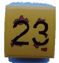 LEGO part Slope, Curved 2 x 2 x 2/3 with Black '23', Medium Nougat Rust Splotches Pattern (Sticker) - Set 70423 15068pb343