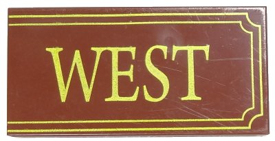 LEGO part Tile 2 x 4 with Yellow 'WEST' and Fancy Outline Pattern (87079pb0005)