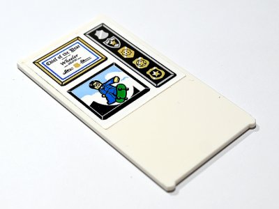 LEGO part Glass for Window 1 x 4 x 6 with 'Chief of the Year Wheeler' Certificate in Frame, Gold Police Badges and Minifigure on Green Skateboard Pattern (Sticker) - Set 60246 (57895pb152)