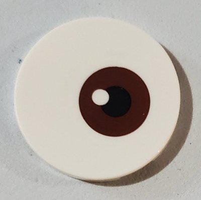 LEGO part Tile, Round 3 x 3 with Reddish Brown and Black Eye Pattern (67095pb002)