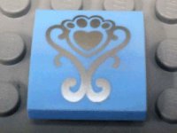 LEGO part Slope, Curved 2 x 2 x 2/3 with Silver Fancy Scroll and Heart Shaped Paw Pattern 15068pb047