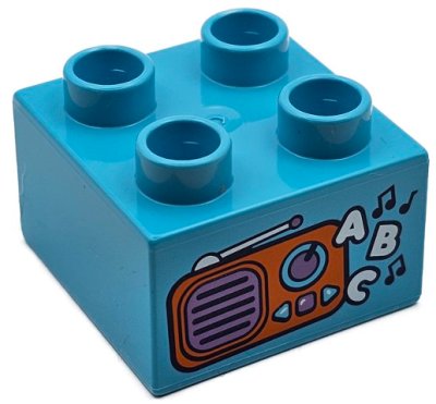 LEGO part Duplo, Stein 2 x 2 mit orange und mittellila Radio, schwarzen Musiknoten und weißem 'ABC'-Muster (3437pb121)