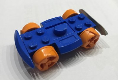 LEGO part Vehicle, Base 4 x 6 Racer Base with Orange Wheels and Light Gray Bumper (30558c06)