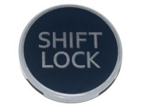 LEGO part Tile, Round 3 x 3 with Silver 'SHIFT LOCK' on Black Background Pattern 67095pb010